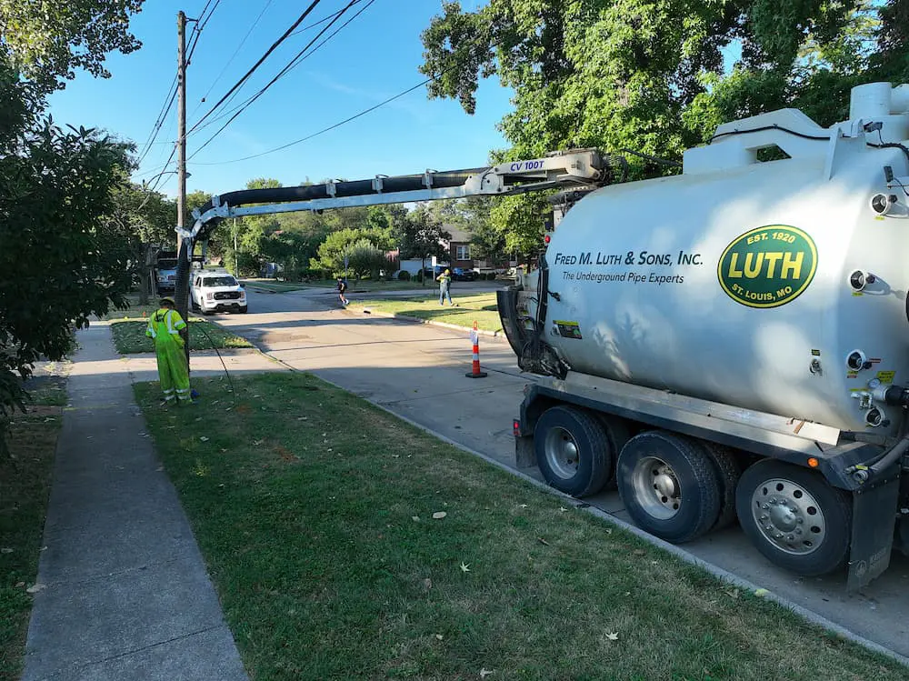 Fred Luth truck with employee running a line into the ground
