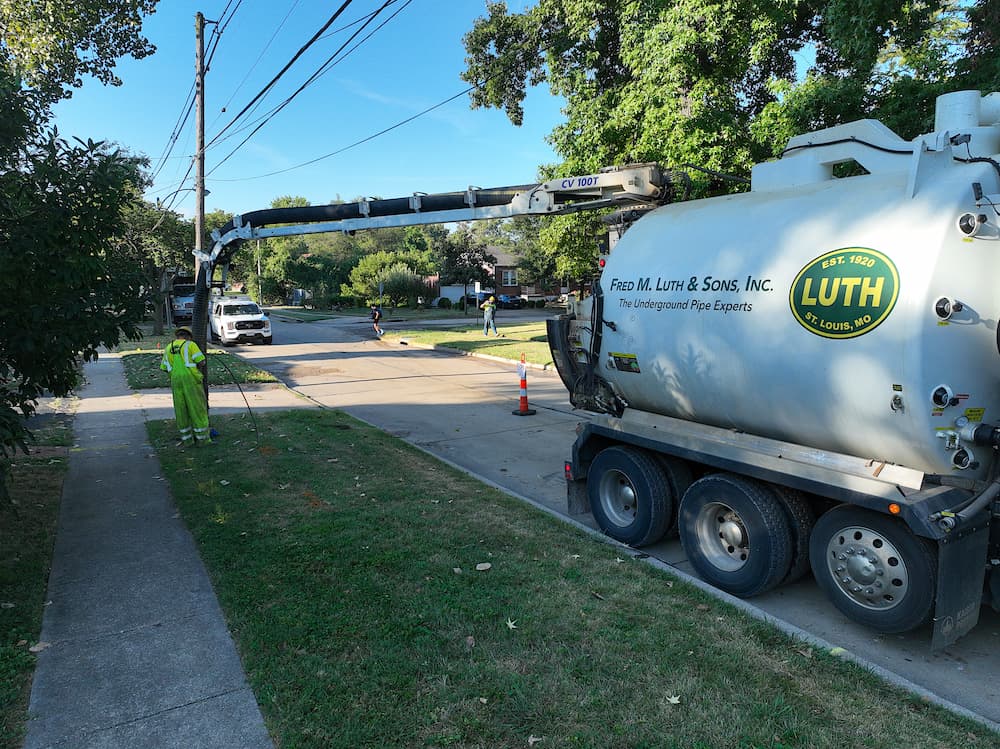 Fred Luth truck with employee running a line into the ground